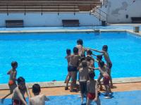 Niños tirando a Alberto a la Piscina